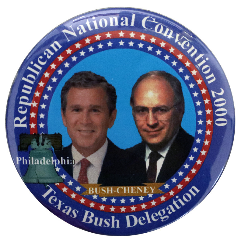 Round button with a layered border of blue and red with white stars. In the center are color photographs of George W. Bush and Dick Cheney. On the left is an illustration of the Liberty Bell with "Philadelphia" written across it in white text. White text around the edge of the button reads "Republican National Convention 2000 BUSH-CHENEY Texas Bush Delegation"