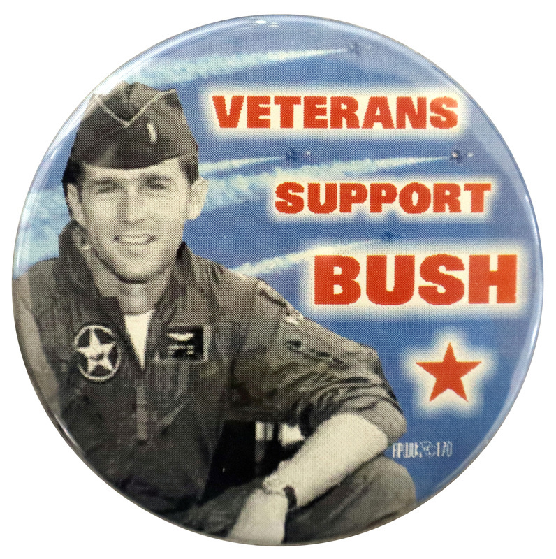 Round button with a black and white photograph of a young George W. Bush in uniform against a color photograph of airplanes in the sky. Red text reads "VETERANS SUPPORT BUSH"