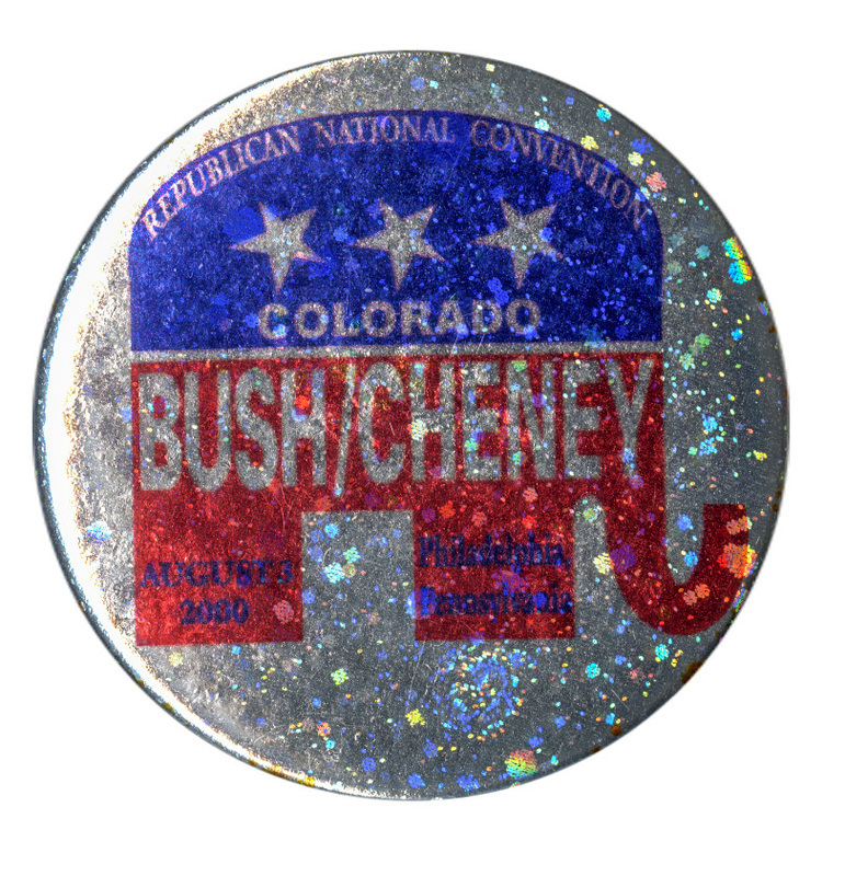 Round, sparkly silver button with a red, white, and blue GOP elephant symbol. Silver and black text within the elephant symbol reads "REPUBLICAN NATIONAL CONVENTION COLORADO BUSH/CHENEY AUGUST 3, 2000 Philadelphia, Pennsylvania"