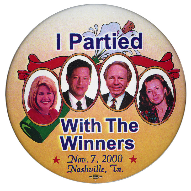 Round, yellow button with color photographs of Tipper Gore, Al Gore, Joe Lieberman, and Hadassah Lieberman against a color illustration of a popping champagne bottle and red ribbon. Black text reads "I Partied With The Winners Nov. 7, 2000 Nashville, Tn."