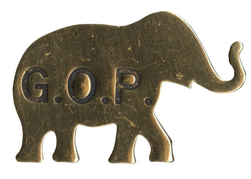 Gold, elephant-shaped button with "G. O. P." stamped on it in black.