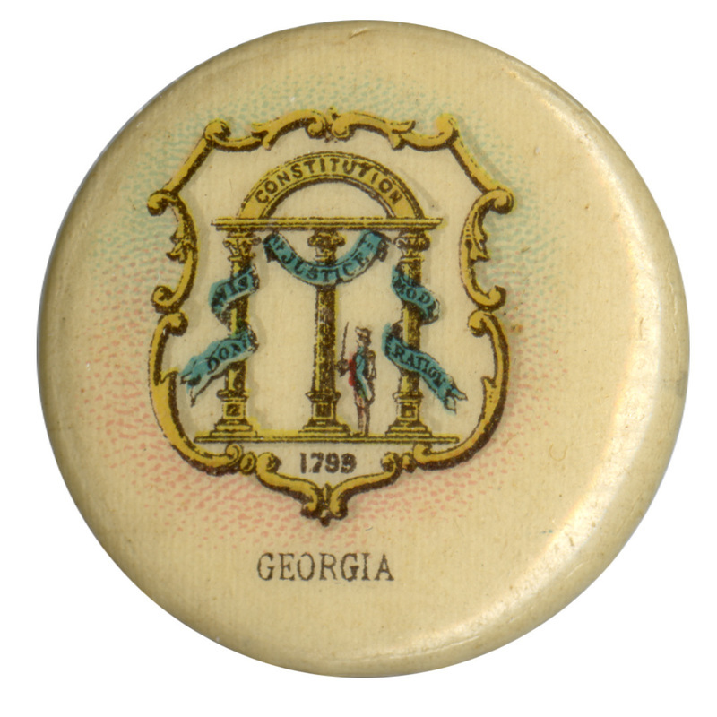 Round, off white button with the state seal of Georgia, three columns supporting an arch labeled "CONSTITUTION", with blue ribbons labeled "WISDOM", "JUSTICE", and "MODERATION". Black text under the seal design reads "GEORGIA".
