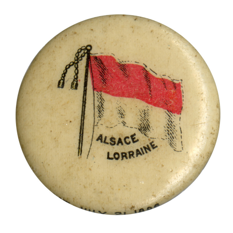 Round, white button with a color illustration of the flag of Alsace, horizontally split into a red upper half and white lower half. Black text reads "ALSACE LORRAINE"