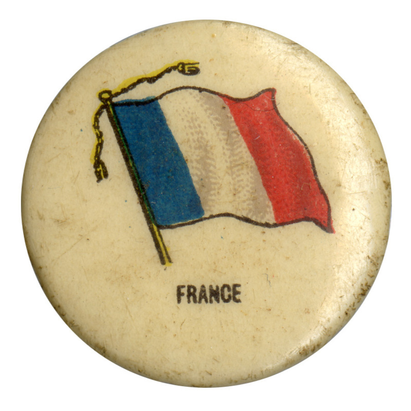 Round, white button with a color illustration of the flag of France, vertically split thirds of blue, white, and red. Black text at the bottom reads "FRANCE."