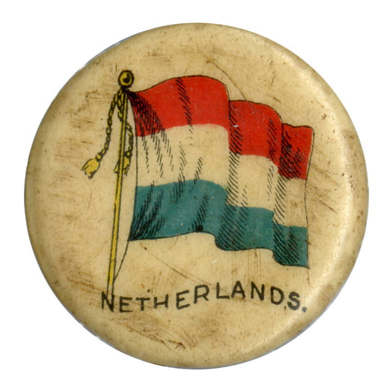 Round, white button with a color illustration of the flag of the Netherlands, horizontal bands of red, white, and blue. Black text at the bottom reads "NETHERLANDS."