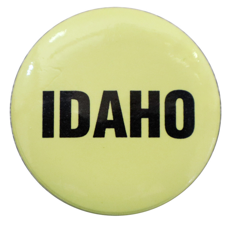 Round, yellow button with black text reading "IDAHO"