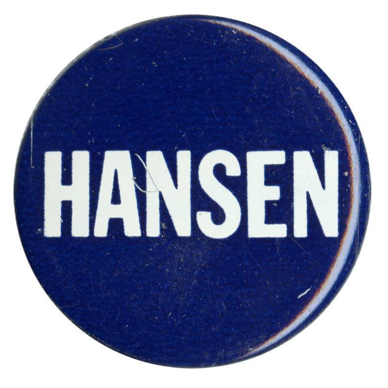 Round, blue button with white text reading "HANSEN"