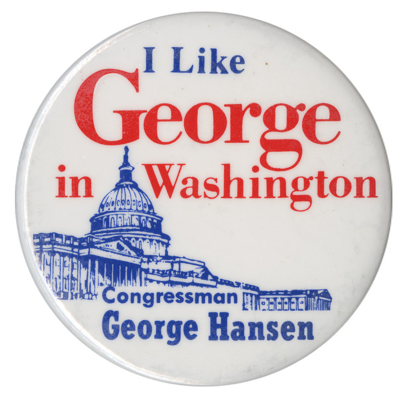 Round, white button with a blue illustration of the US Capitol. Blue, red, and white text reads "I Like George in Washington Congressman George Hansen." The words "George" and "Washington" are highlighted in red. 