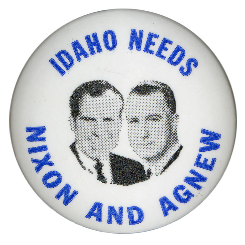 Round, white button with black and white photographs of Richard Nixon and Spiro Agnew. Blue text reads "IDAHO NEEDS NIXON AND AGNEW"