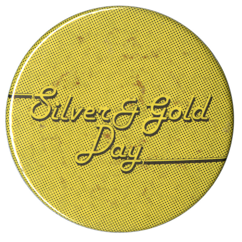 Round, yellow button covered in small black dots. Yellow and black text reads "Silver & Gold Day"