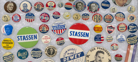 A selection of political buttons on a foam background