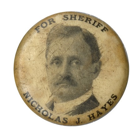 Round, white button with a portrait of Nicholas J. Hayes and the text: "For sheriff Nicholas J. Hayes".