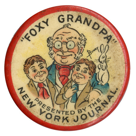Round, white button with a red border, and three cartoon figures of two children and an older man, with black text reading "Foxy Grandpa" and "Presented by the New York Journal". 