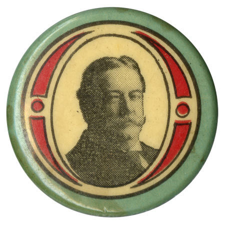 Round, pale green button with a decorative white and red border and a black and white portrait of William Howard Taft. 