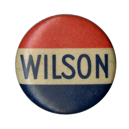 Round button with three red, white, and blue horizontal stripes, and blue, bolded font reading "Wilson" along the white stripe. 