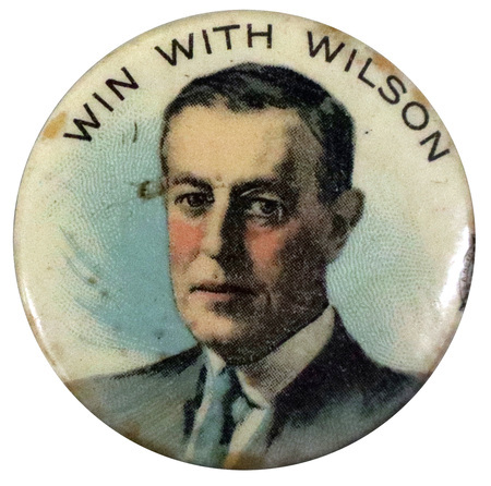 Round, white button with a portrait of Woodrow Wilson at the center, and black text reading "Win with Wilson" at the top.