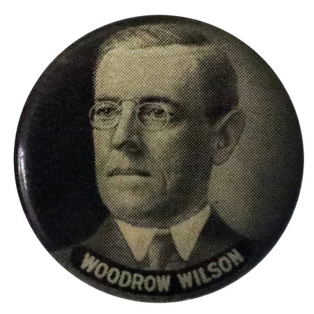 Round, gray button with a black and white portrait of Woodrow Wilson, with white text at the bottom reading "Woodrow Wilson."
