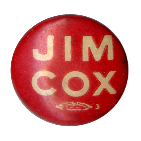 Round, red button with white bold text reading "Jim Cox".