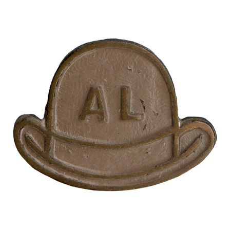 Small, round pin in the shape of a brown bowler hat labeled "AL."
