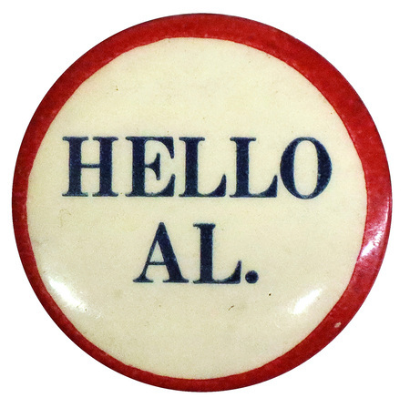 Round, white button with a red border and blue text reading "Hello Al.".