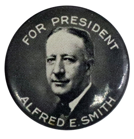 Round, gray button with a black and white portrait of Alfred E. Smith, and white font reading "For President Alfred E. Smith". 
