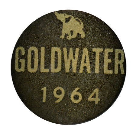 Round, black button with a gold image of an elephant and gold text reading "Goldwater 1964"