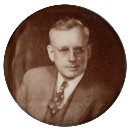 Round button with a sepia-toned portrait of Alfred Landon.