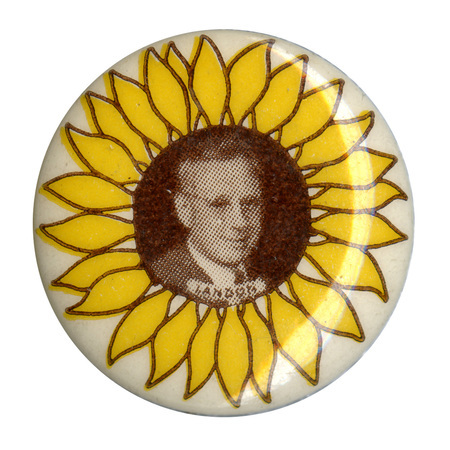 Round, white button with a yellow sunflower, and a sepia-toned portrait of Alfred Landon. Brown text reading "Landon" sits below the portrait. 
