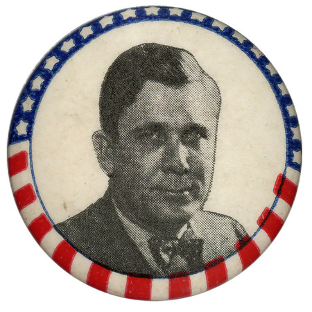 Round, white button with US flag border and a black and white portrait of Wendell Willkie. 