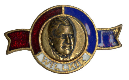 Button featuring a textured and lifted portrait of Wendell Willkie. Text reads "Willkie" underneath the portrait. It has a circular gold frame with red, white, and blue enamel accents.