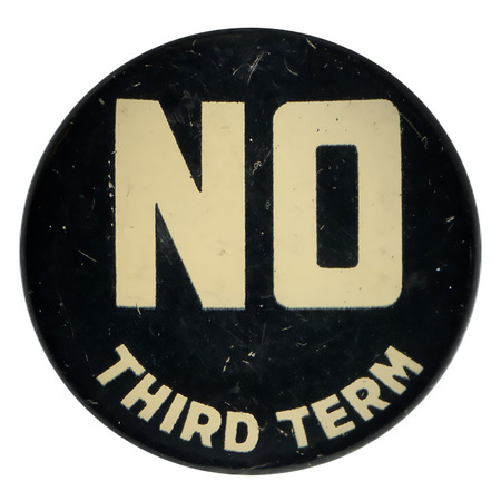 Round, black button with bold, white text reading "NO third term". 