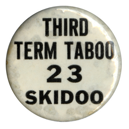 Round, white button with black text reading "third term taboo 23 skidoo". 