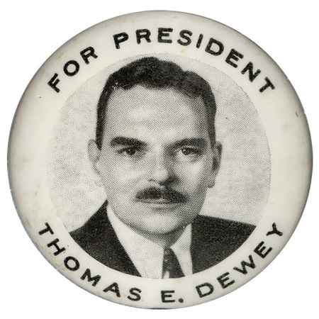 Round, white button with a black and white portrait of Thomas Dewey. Black text encircles the portrait and reads "For President Thomas E. Dewey". 