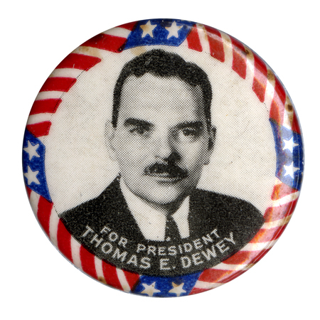 Round, white button with a grayscale portrait of Thomas Dewey and a US flag border. White text below the portrait reads "For President Thomas E Dewey". 