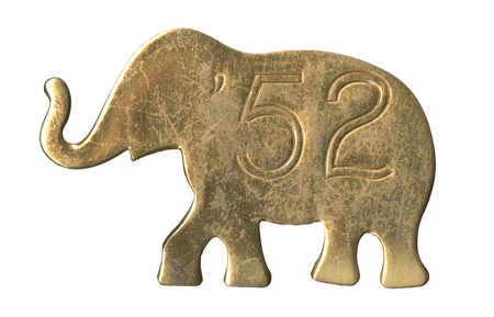 Gold, elephant-shaped button with text reading '52".