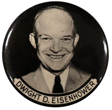 Round, black button with a grayscale portrait of Dwight D. Eisenhower at the center. A white banner below the portrait reads "Dwight D. Eisenhower" in black text. 