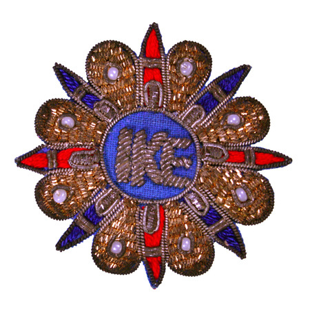 Fabric button with gold bullion wire with beads, and red and blue embroidery accents. The word "IKE" is embroidered at the center of the button. 