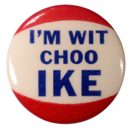 Round, white button with red accent borders at the top and bottom. Bold, blue text reads "I'm wit choo Ike". 