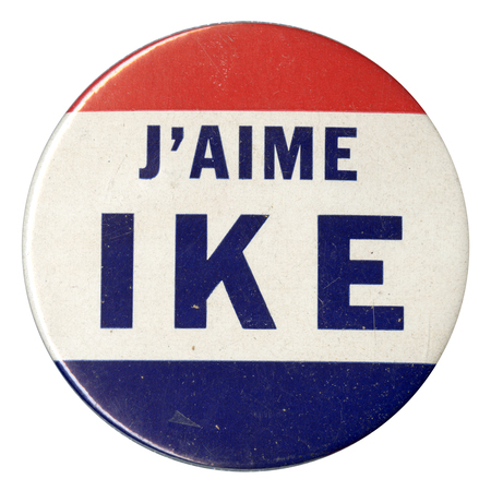 Round button with three horizontal stripes of red, white, and blue. Bold blue font reads "J'aime Ike" (French for "I love Ike") across the center white stripe. 