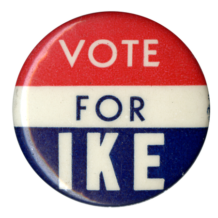 Round button with three horizontal stripes of red, white, and blue. Text across all three stripes reads "Vote for Ike". 