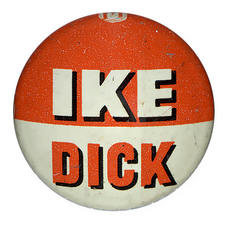 Round, orange and white button. Text reads "Ike Dick".