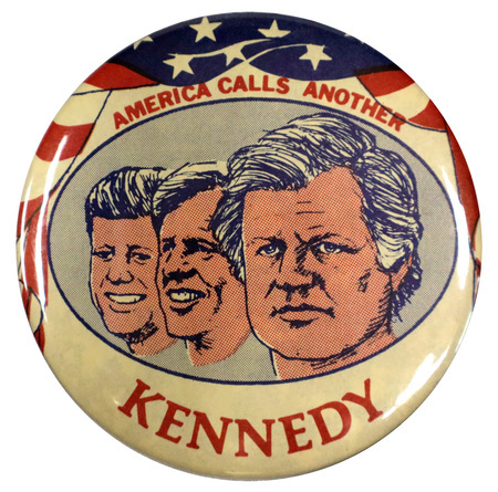 Round, white button with portraits of John F. Kennedy, Robert F. Kennedy, and Ted Kennedy. Ted Kennedy's portrait is foregrounded. The portraits are framed by a US flag design. Red text reads "America calls another Kennedy". 