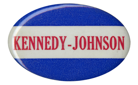 Oval, blue button with a white horizontal stripe across the center. Red text reads "Kennedy-Johnson" along the white stripe. 