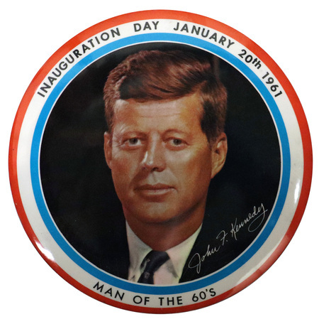 Round button with a red, white, and blue border. A color portrait of John F. Kennedy is at the center. Black text reading "Inauguration day January 20th 1961 Man of the 60's" encircles the portrait. 