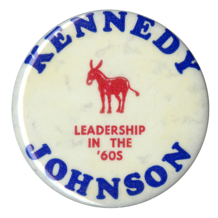 Round, white button with a red graphic of a donkey. Red and blue text reads "Kennedy Johnson Leadership in the '60s".