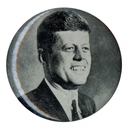 Round button with a grayscale portrait of John F. Kennedy.