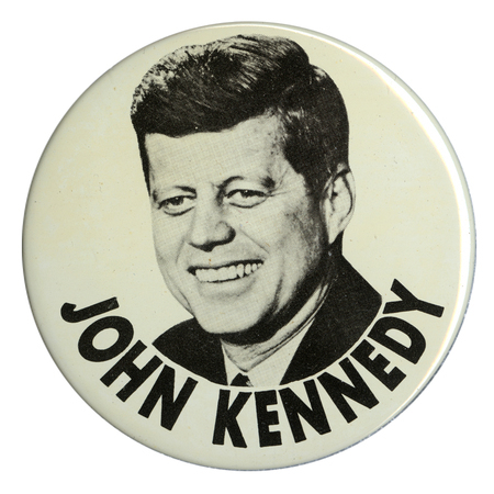 Round, white button with a large portrait of John F. Kennedy. Below the portrait is black text that reads "John Kennedy".