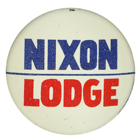 Round, white button with blue and red text reading "Nixon Lodge", with a thin line between "Nixon" and "Lodge". 