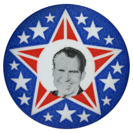 Round button featuring a red and white star with a grayscale portrait of Richard Nixon inside. White stars surround it.