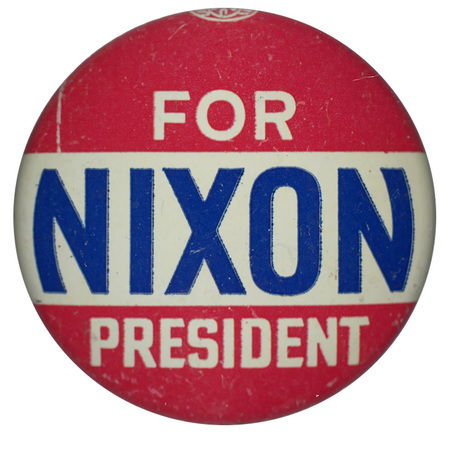 Round button with three horizontal stripes of red, white, and red. White and blue text reads "Nixon for President" across all three of the stripes. 